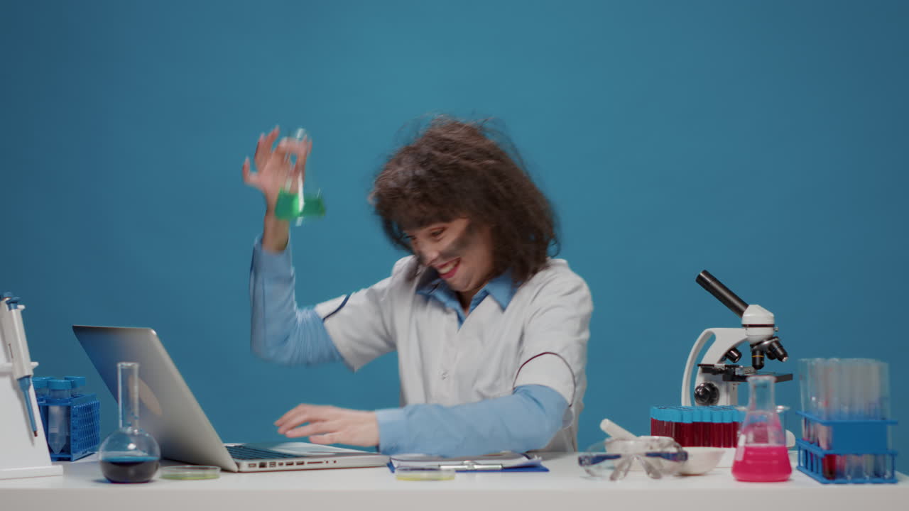 Insane foolish female chemist using laptop and beaker