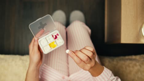 woman taking medication in bed