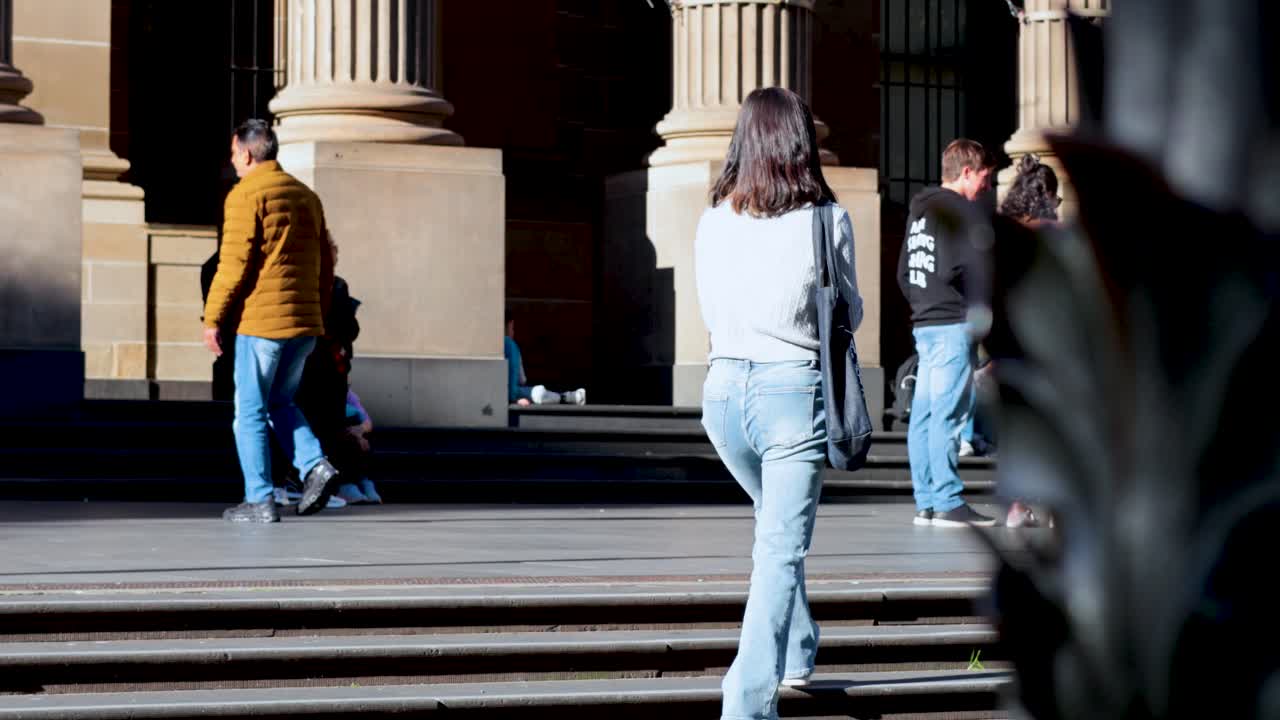 Individuals walking and interacting outside library