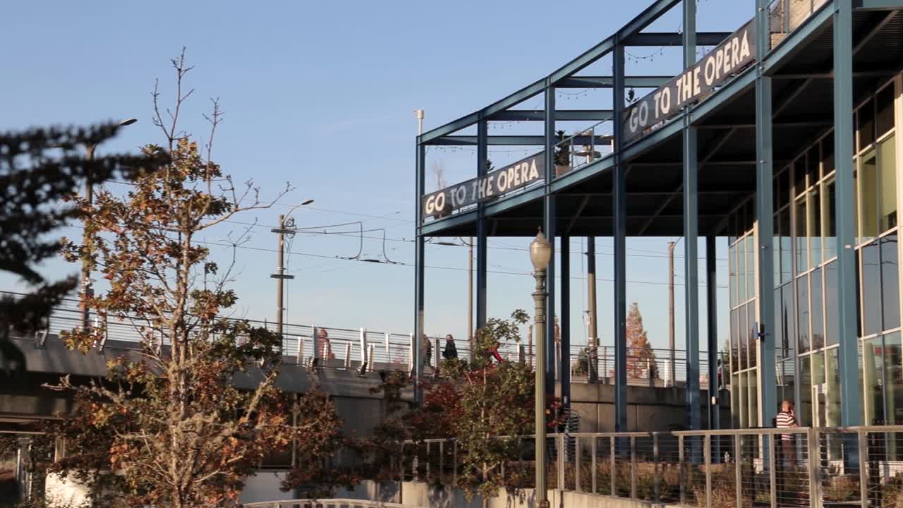 Cyclists on a Modern Bridge Overlooking a City
