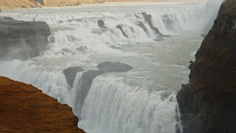 High-angle-view-of-the-Gullfoss-waterfall-rapid-in-slow-motion-on-a-sunny-day