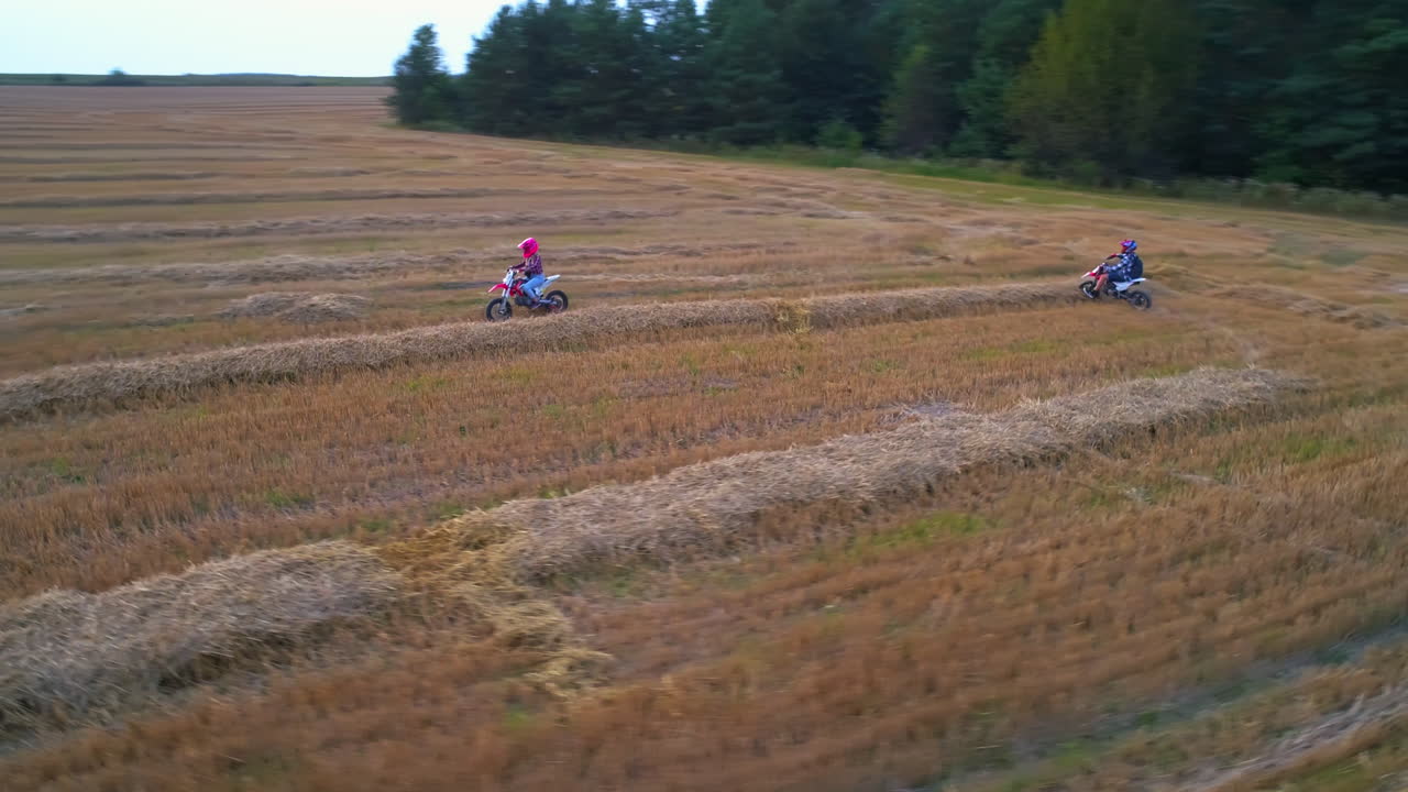 Kids Riding Dirt Bikes in a Hay Field