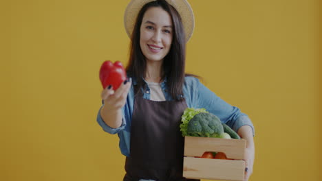 woman farmer holding fresh vegetables