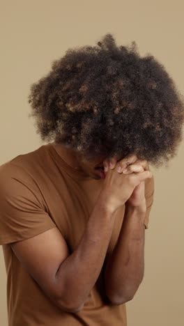 man praying with clasped hands