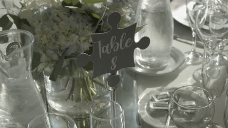 prepared table with glasses and flowers for wedding ceremony