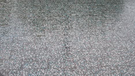 reflection of a decorative stone surface in water