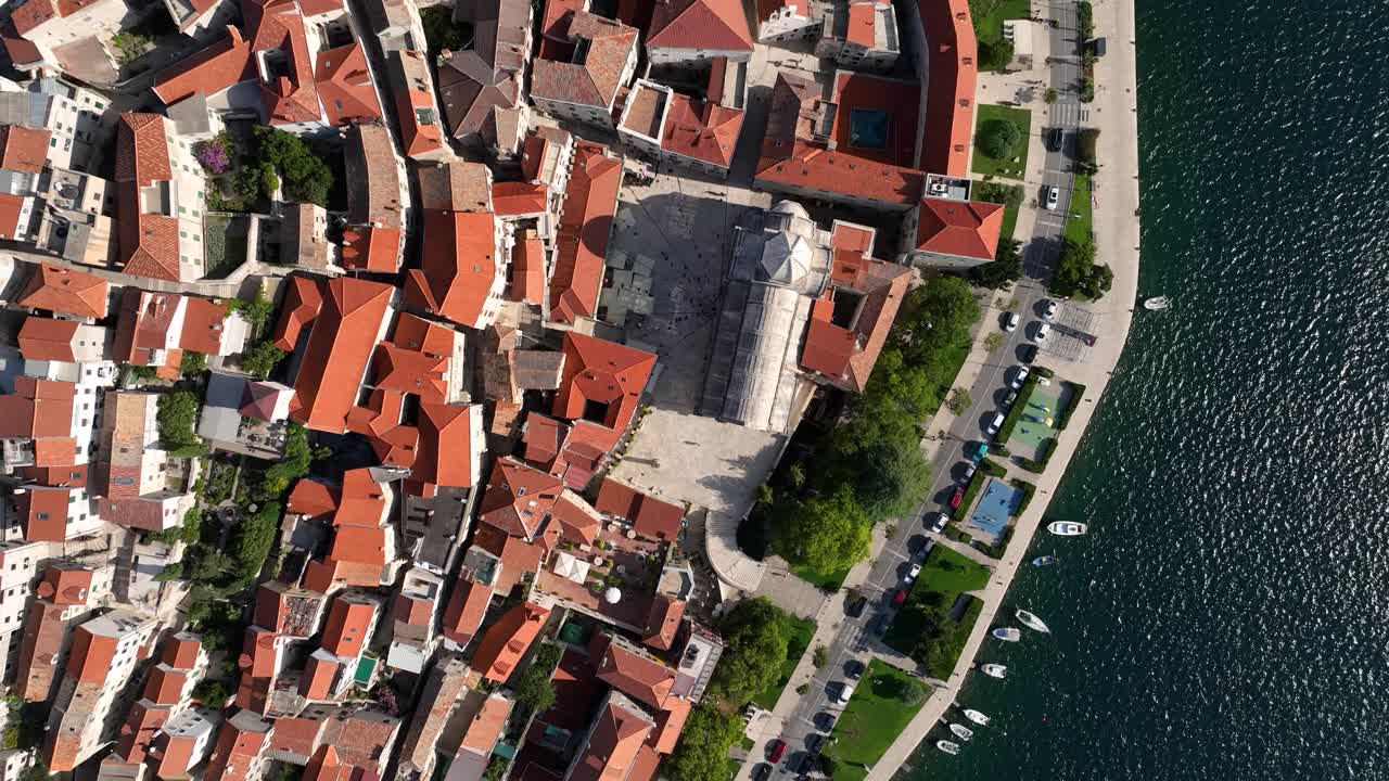 Sibenik’s historic center, showing rooftops, streets, and waterfront, aerial view