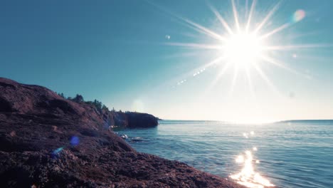 The-rocky-Lake-Superior-shoreline-at-Baraga's-Cross-Minnesota,-with-very-calm-waters-at-sunrise