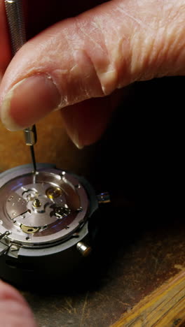 close-up of horologist repairing a watch