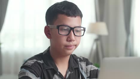 teenager studying on laptop