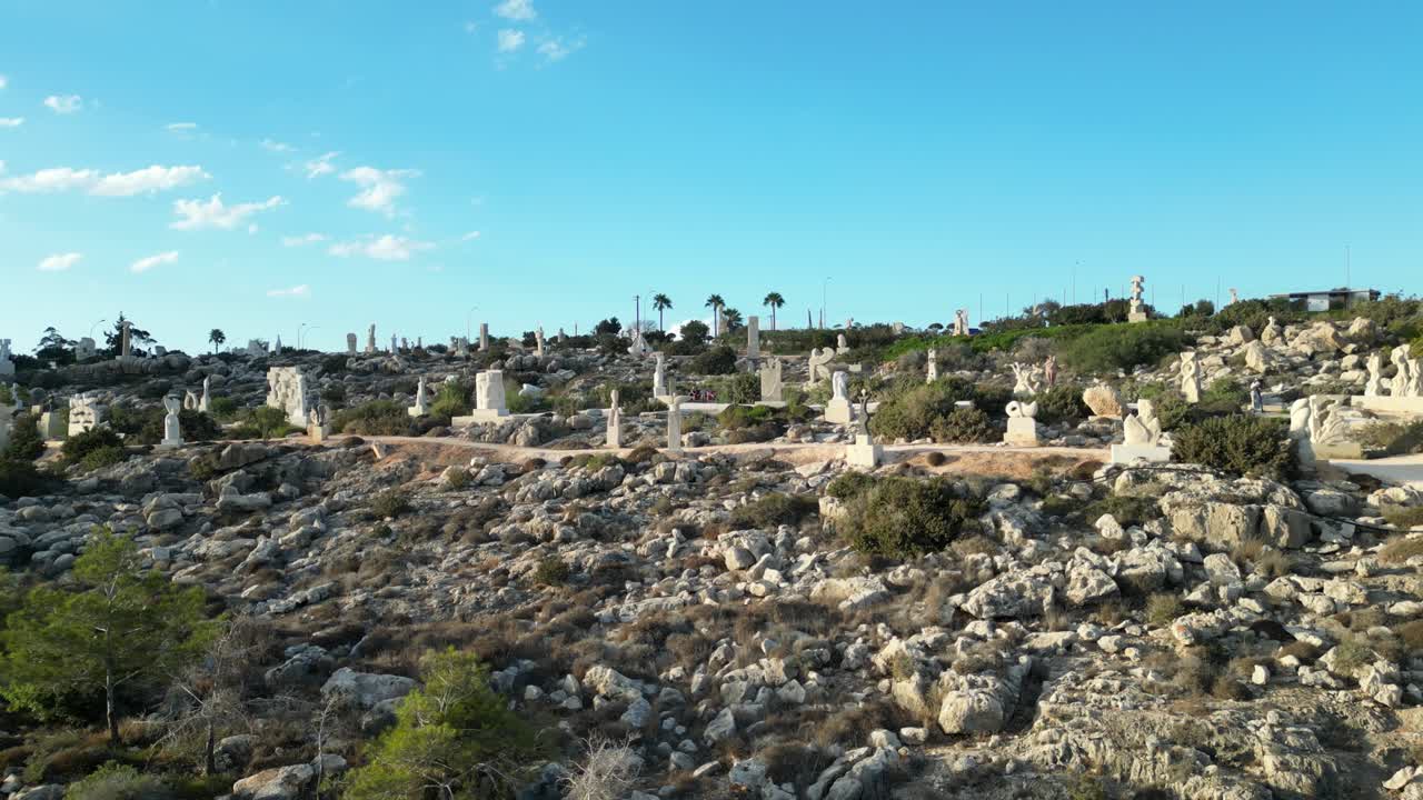 Wide shot of Sculpture Park in Ayia Napa, Cyprus with statues dotting the rugged terrain