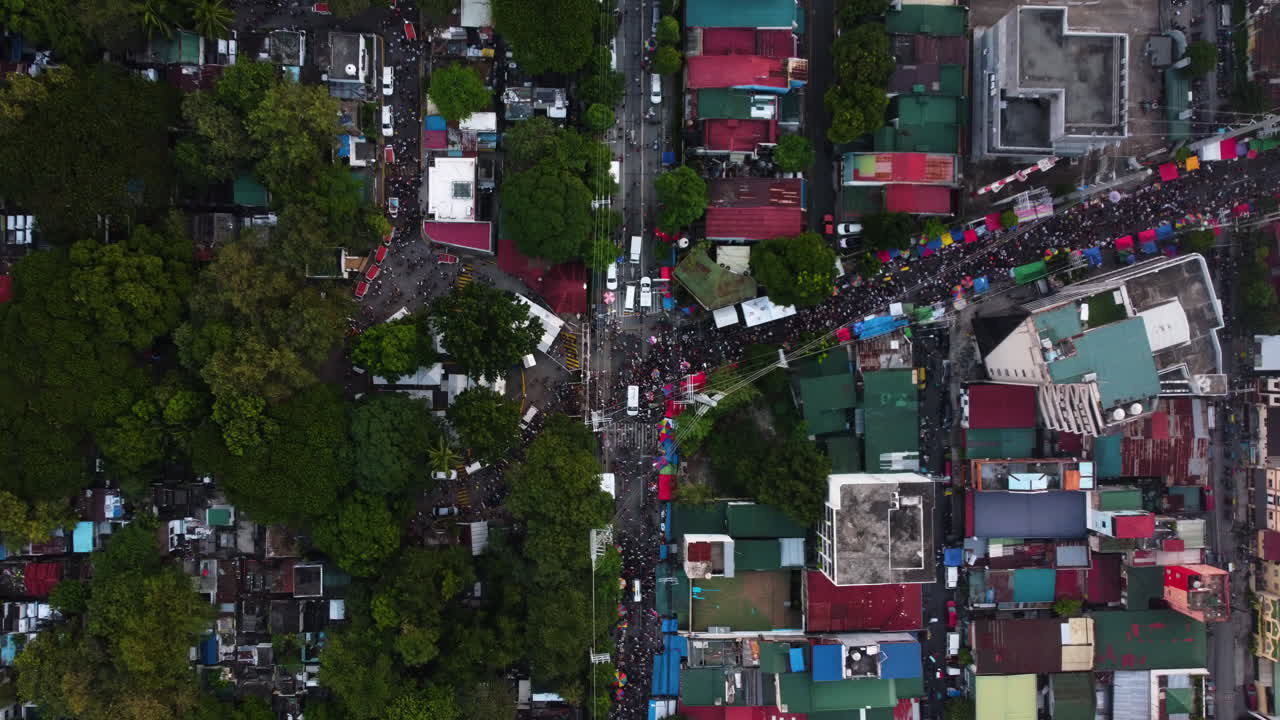Cenital drone shot of crowd jammed streets of Makati, Undas in Philippines