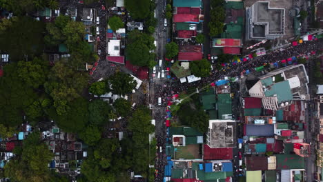 cenital drone shot of crowd jammed streets of makati, undas in philippines