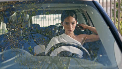 rich woman posing vehicle looking camera confidently close up. lady sitting car