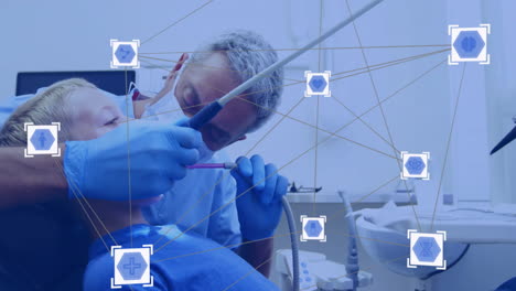 Animation of network of connections with icons over caucasian male dentist with his young patient