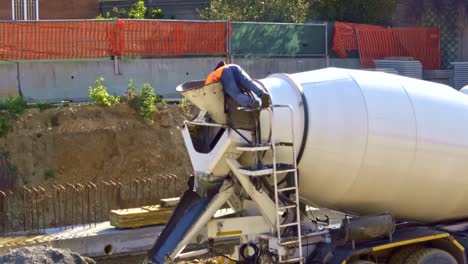 lonely worker operates the concrete mixer on a construction site