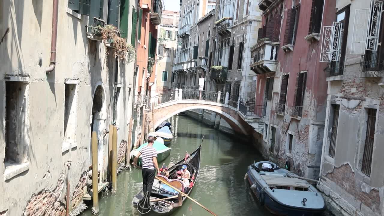 Charming Venice canal with bridge and colorful old buildings.