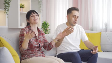 Married-couple-overwhelmed-by-the-heat-at-home.