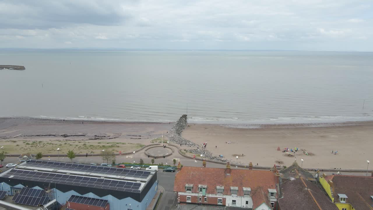 Aerial view of the Minehead steam railway station England's longest heritage line, running 20 miles between Minehead and Bishops Lydeard. Drone rotating to the right showing Minehead beach and town