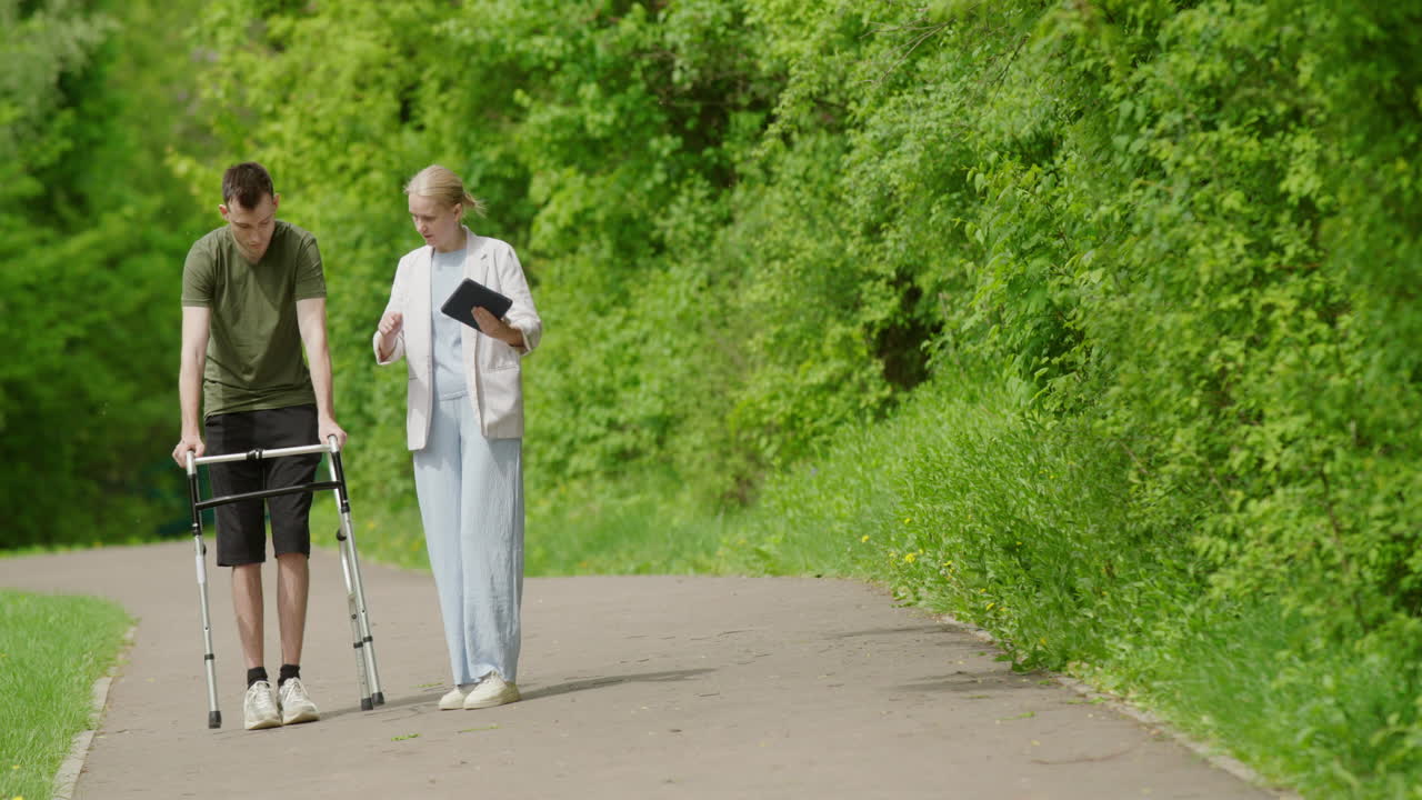 Person with walker and doctor walking in a park
