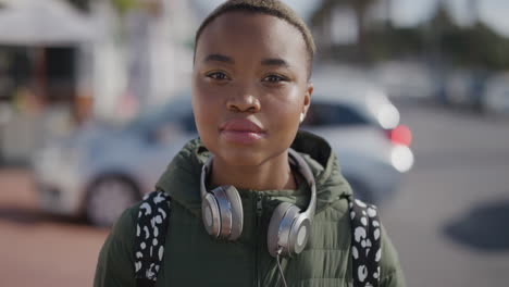 portrait of young beautiful african american woman looking serious wearing headphones