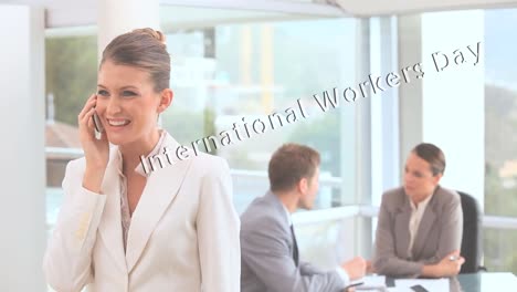 Animation-of-international-workers-day-text-moving-over-caucasian-business-people-in-office