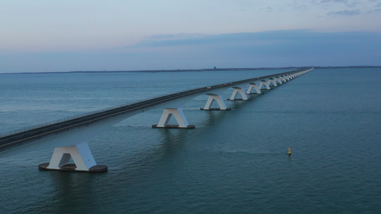 The Zeelandbrug bridge stretching across the sea in the evening