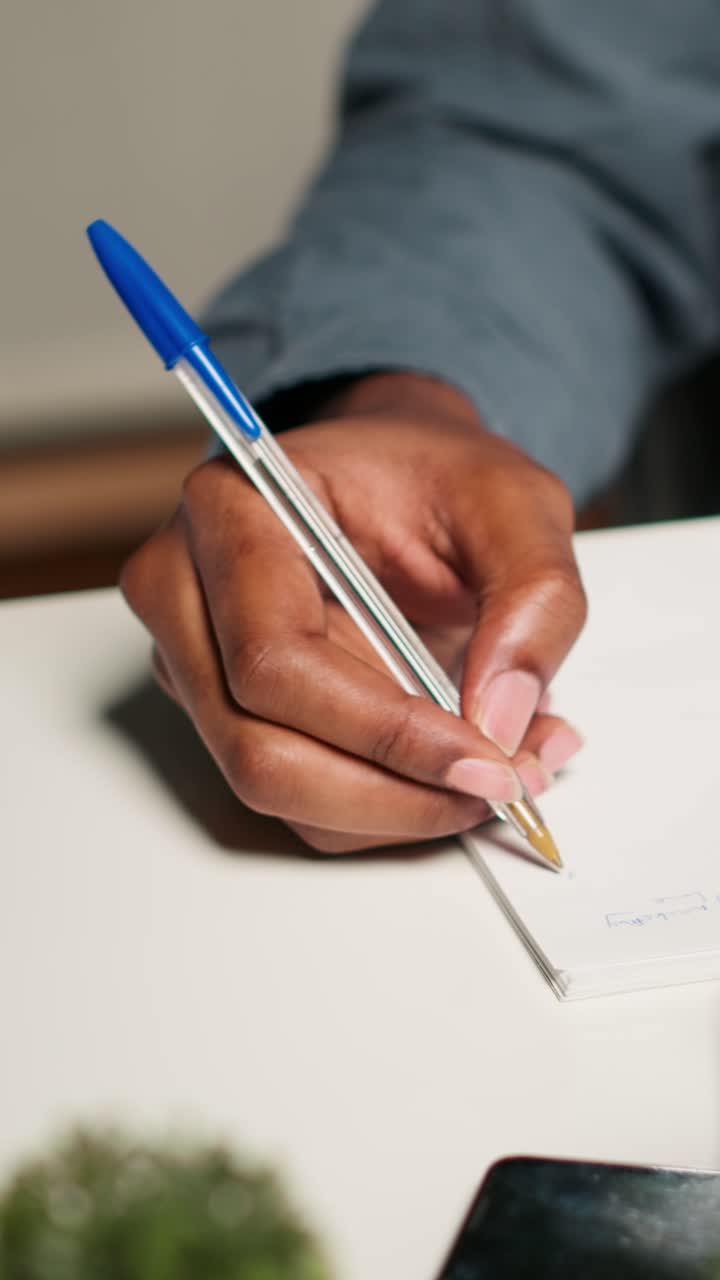 Hand writing on paper with a pen