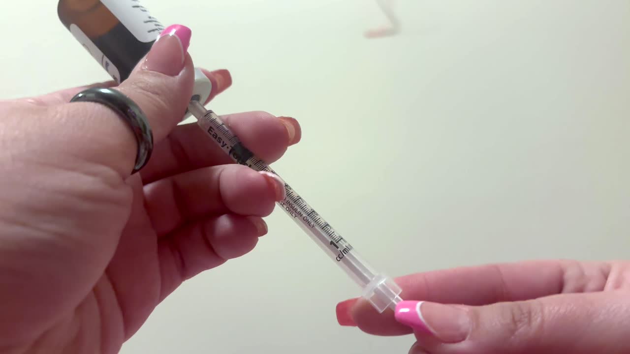 Up close showing syringe needle filling up with Ozempic or Wegovy or Semaglutide medicine for weight loss