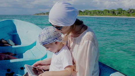 Mother-and-son-using-pad-while-traveling-by-sea