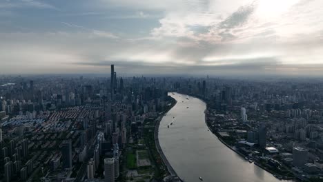 drone aerial view of buildings, cityscape and river in downtown