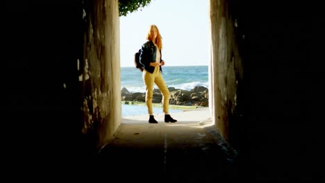 woman standing with backpack in the beach 4k