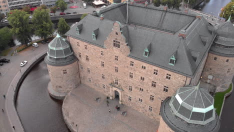 wide angle shot from a drone flying towards örebro castle in sweden