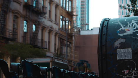 Close-Up-Of-Mailbox-By-Rack-Of-Bicycles-For-Hire-In-New-York