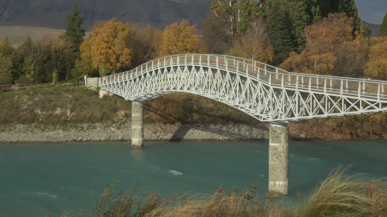 Maclaren Footbridge Across The Outlet Of Lake Tekapo In The Mackenzie Country, New Zealand. Static Shot