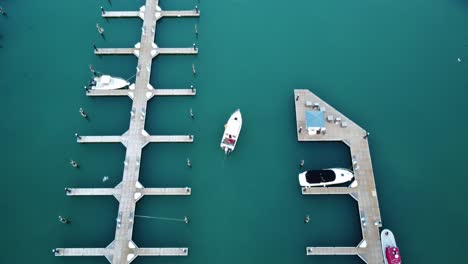 aerial drone tracking a small boat leaving the marina of port washington harbor, wisconsin, usa