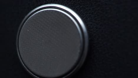 single lithium button cell battery, closeup on dark 4k