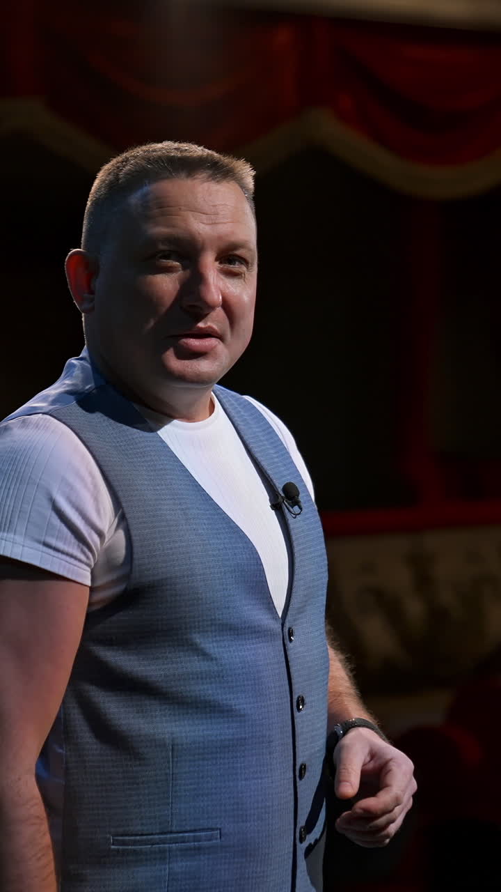 Actor in medical mask on theatre scene. Man rehearsing on stage and taking off protective mask while leading monologue. Pandemic in the world. Vertical video