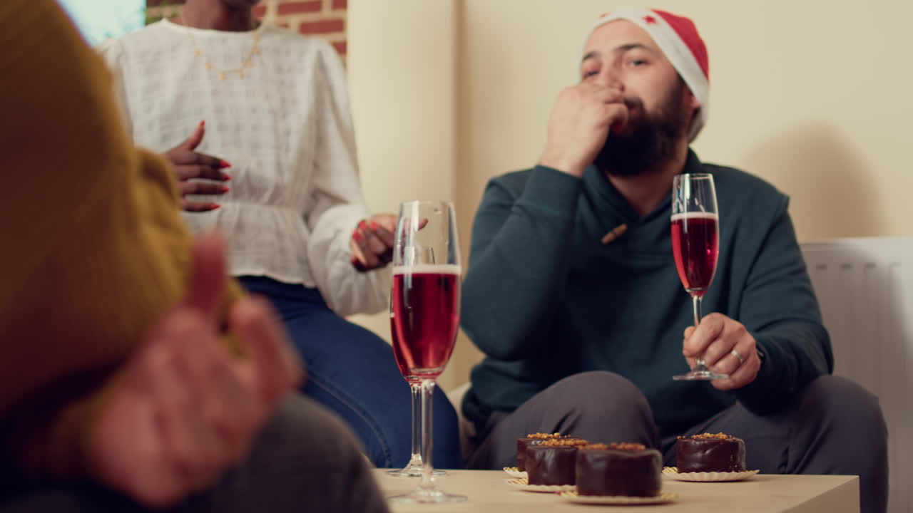 Diverse people drinking glasses of wine at holiday festivity