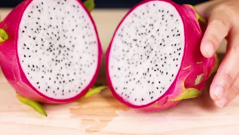 hands slicing and arranging fresh dragon fruit