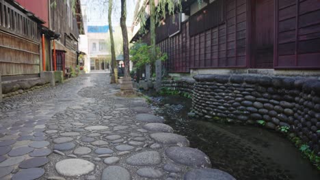 stream running through gujo hachiman town streets, gifu, japan