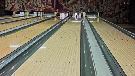 bowling ball rolling down the alley leaving two pin untouched