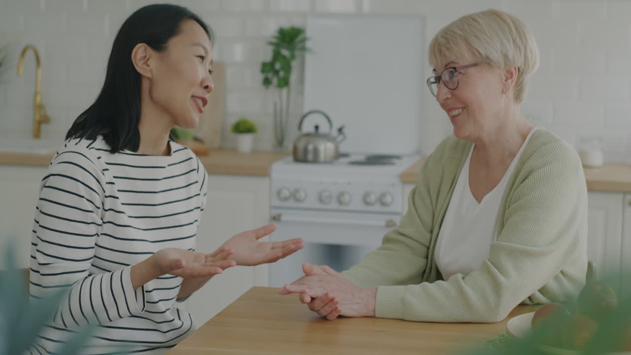 Mother and Daughter Conversation in Kitchen