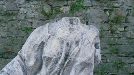 old headless woman statue in the center of the park, close-up shot