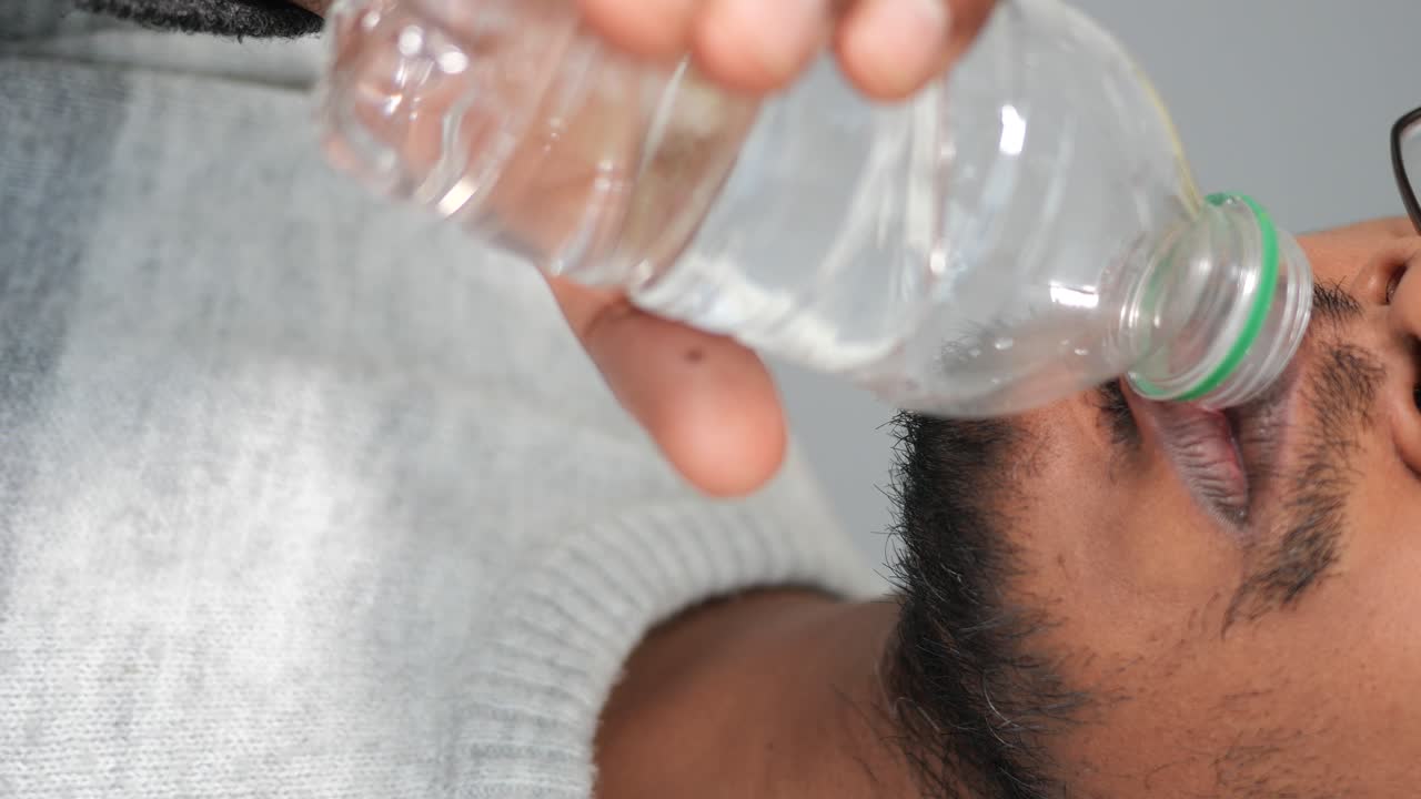 Man Drinking Water from Bottle