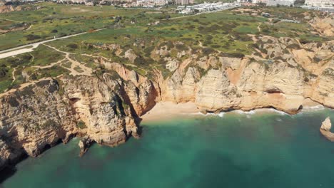 colourful scenic coastline landscape of lagos in algarve, portugal - aerial high slide shot