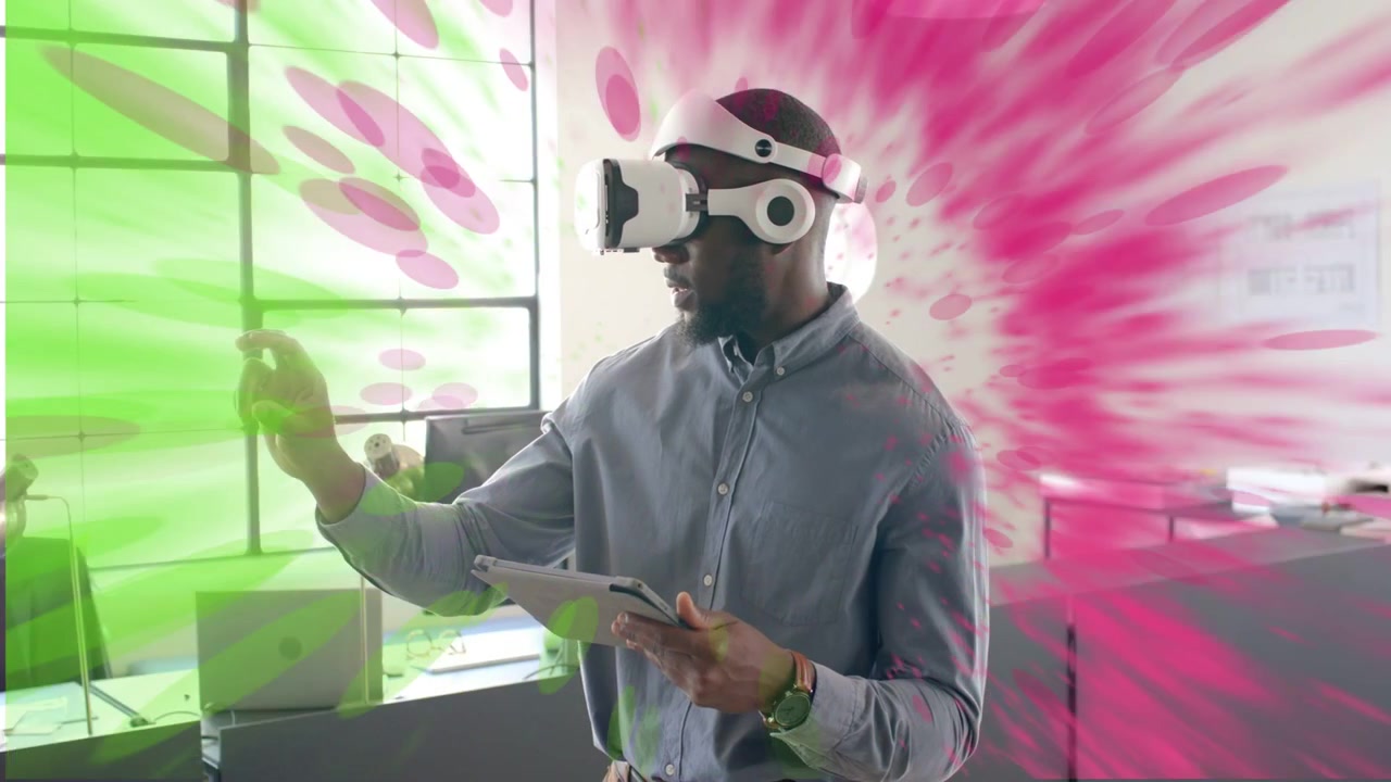 Man wearing VR headset with tablet, raising hand, expanding green-pink ring around him, testing UI