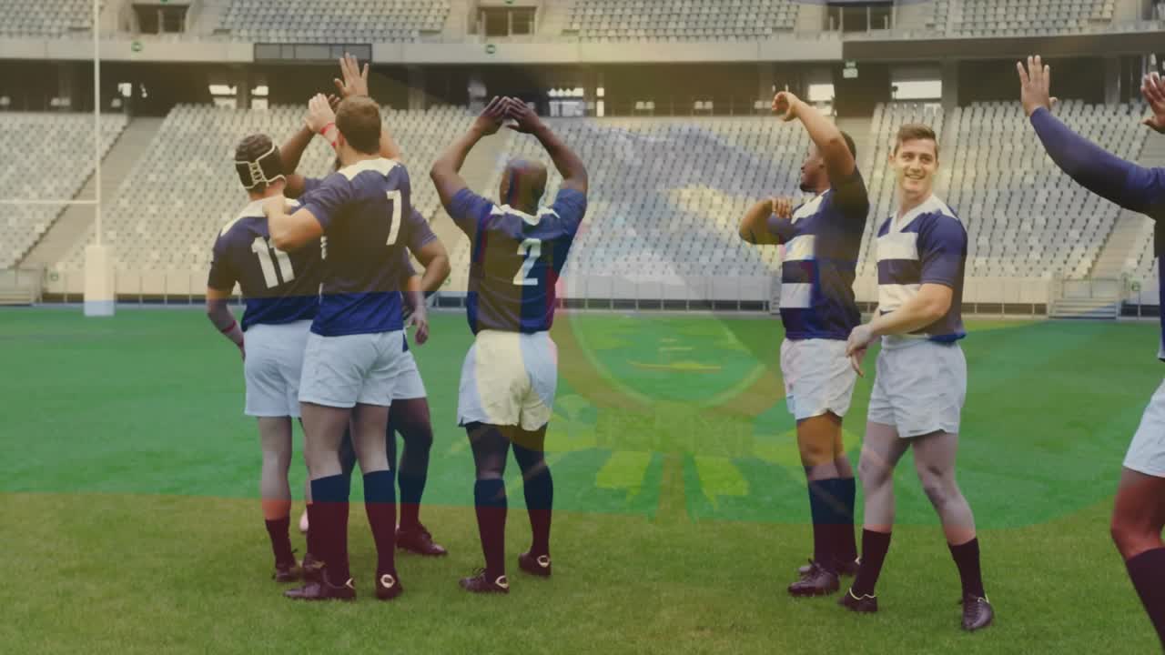 After scoring try rugby teammates forming circle on pitch raising arms and exchanging high-fives