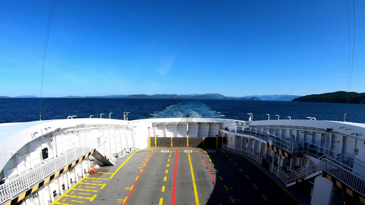 Stern panoramic view from deck of ferry Lysøy - Gas and electricity powered ship -  Handheld static shot showing empty ferry deck underway between Halhjem and Sandvikvåg in Norway
