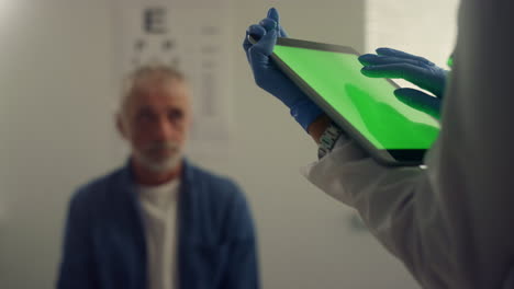 Green-screen-tablet-touching-doctor-hands-close-up.-Therapist-using-pad-computer